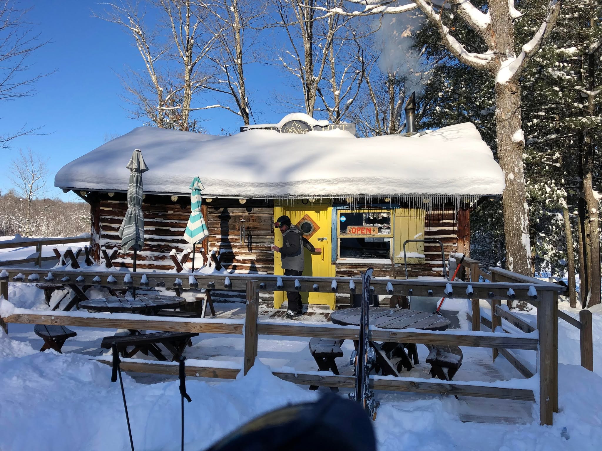 The Wine Hut log cabin in winter on the shore of Weber Lake
